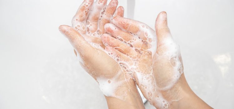 Women's hands in soapy foam. Hand hygiene and health concept.